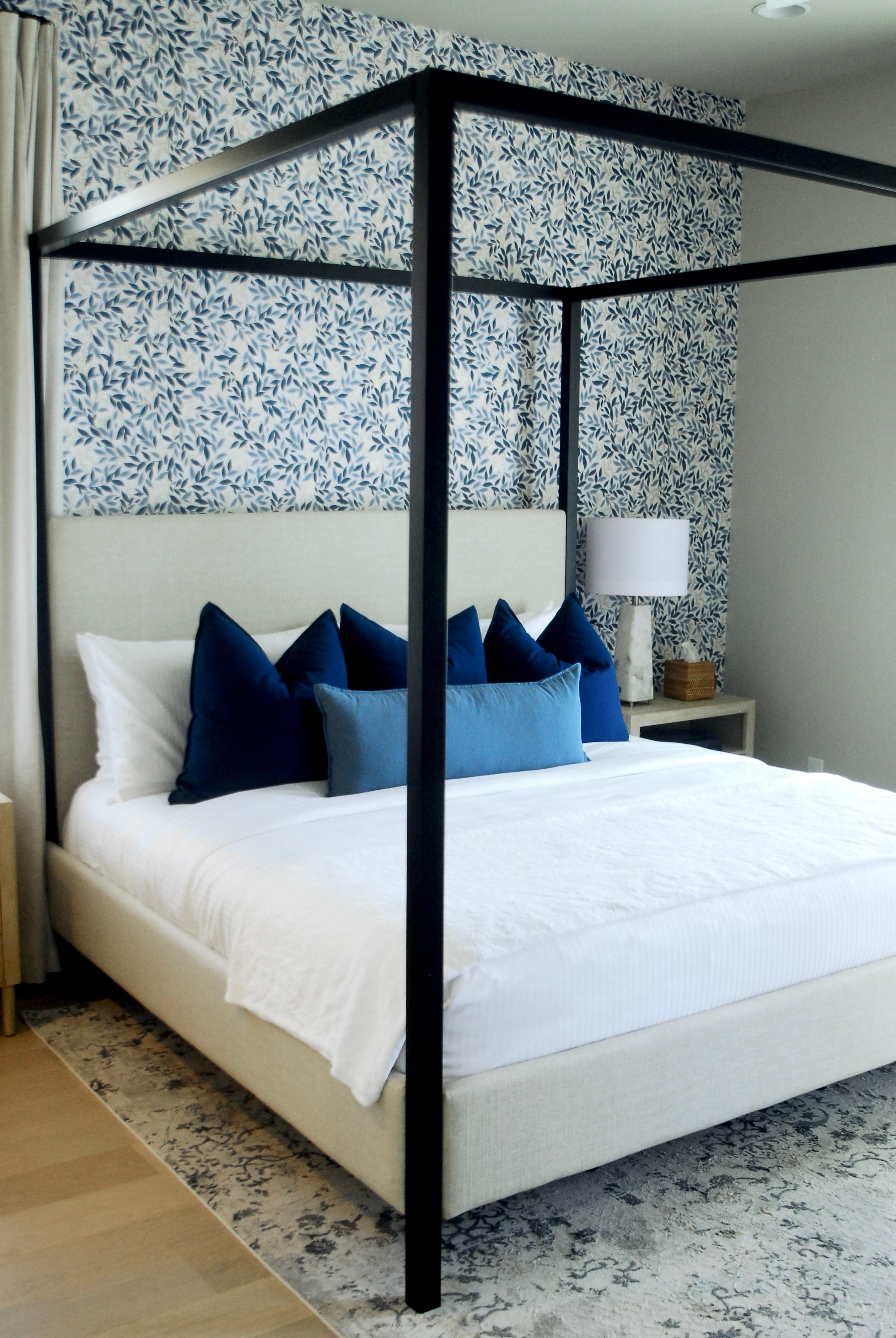 Elegant bedroom with floral wallpaper and cream furnishings